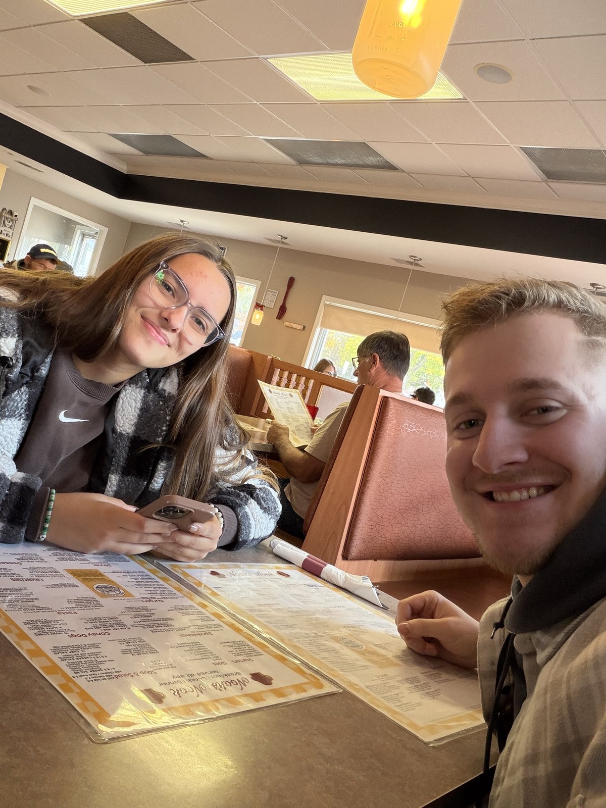 Joseph and Maria at a diner booth with menus