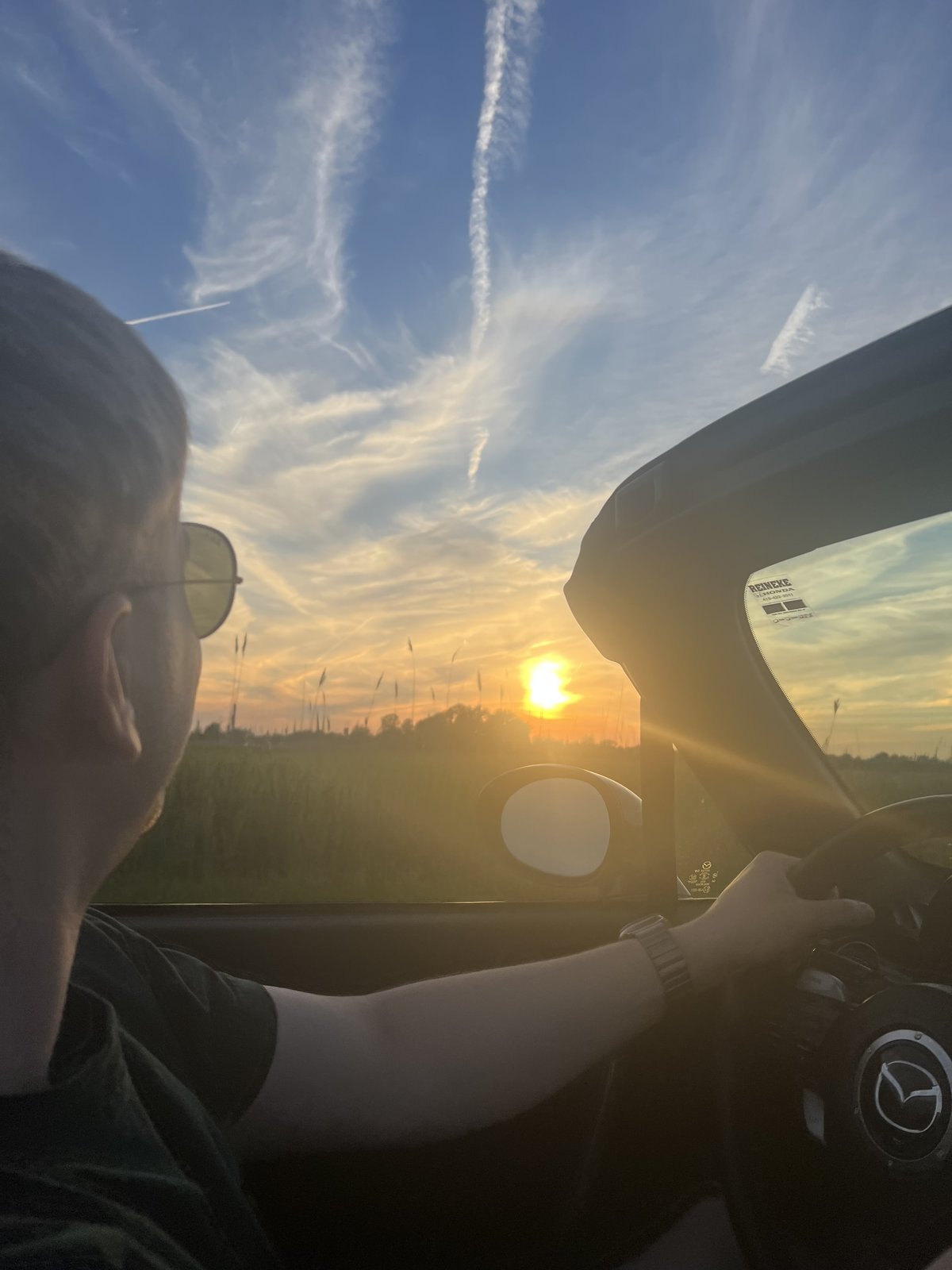 Joseph driving the Miata at sunset, top down