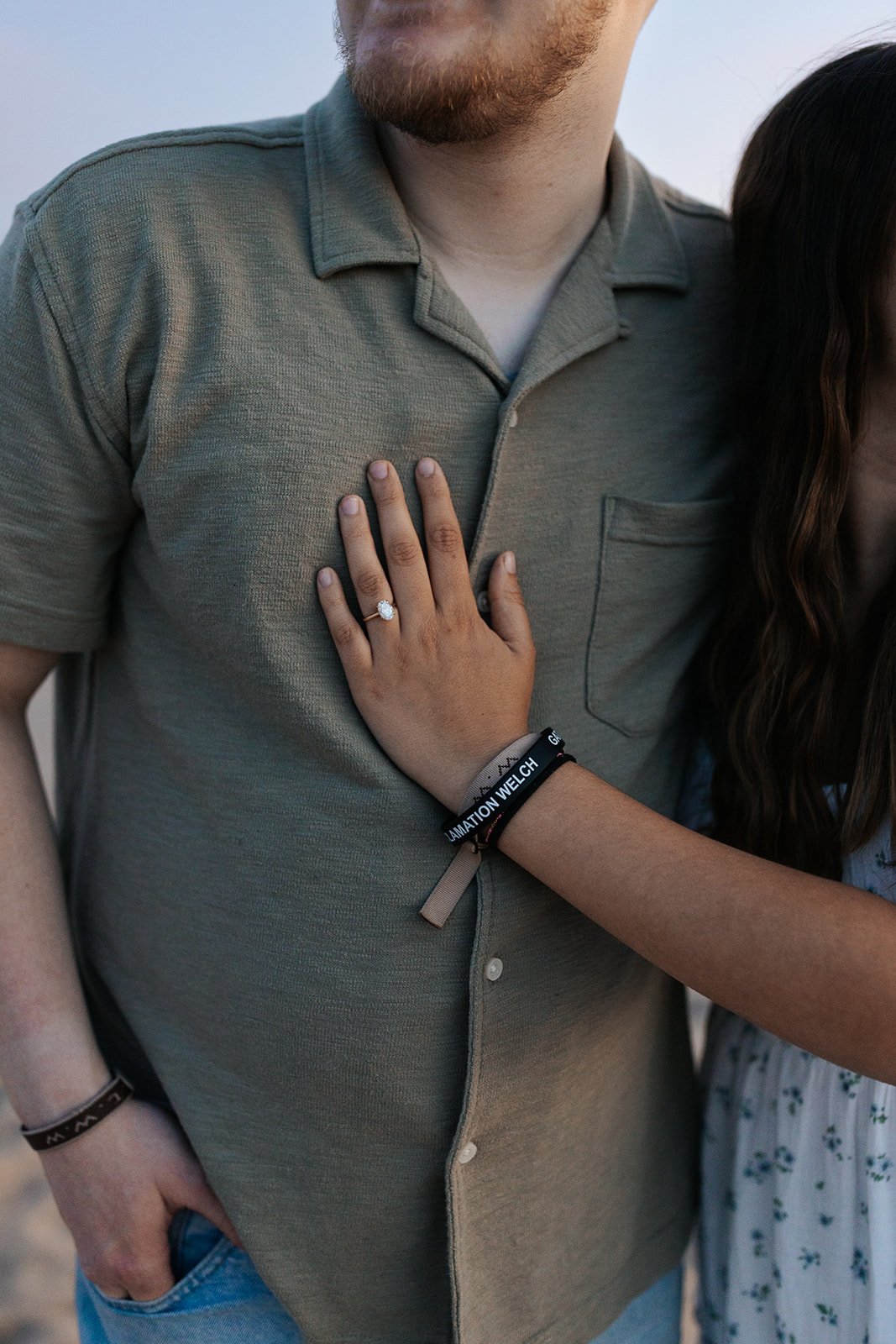 Maria's hand on Joseph's chest, showing the tulip-set engagement ring